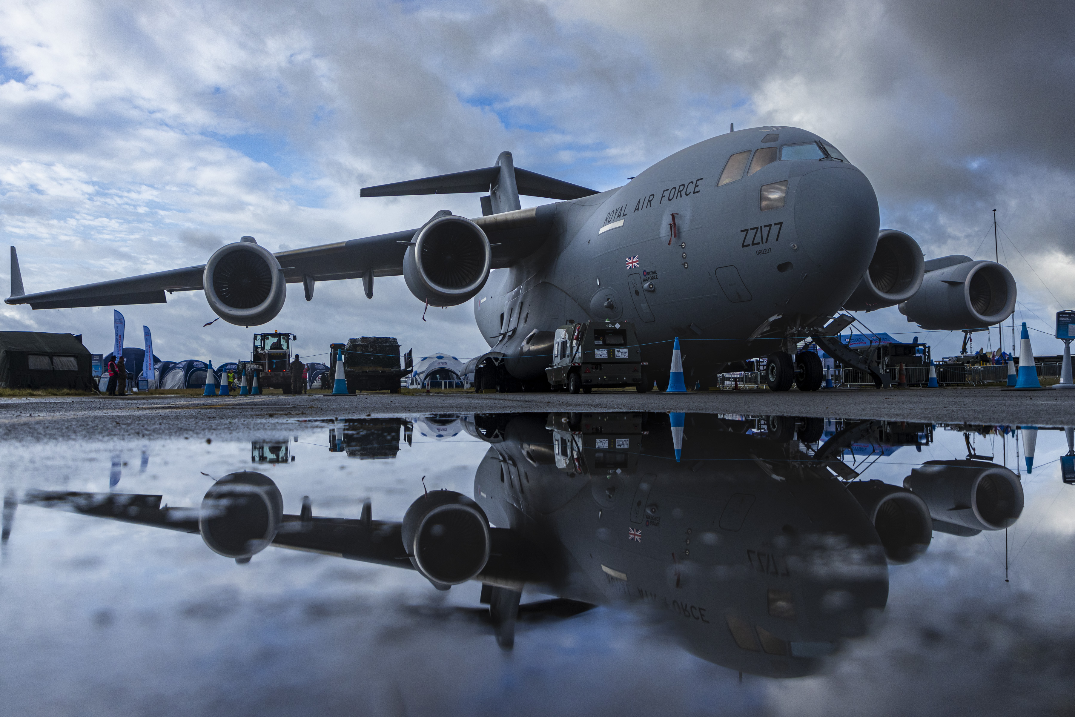 C17 aircraft on wet runway, perfectly reflected in the water