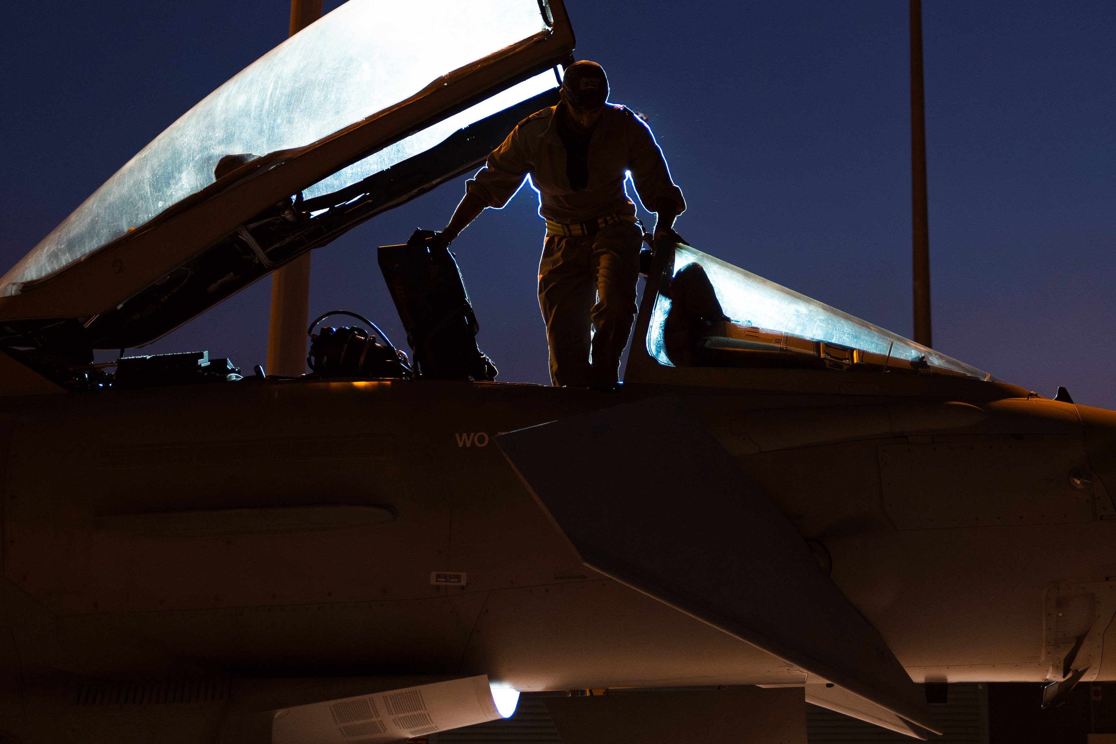 Silhoutte of serviceperson at the cockpit of a Typhoon.