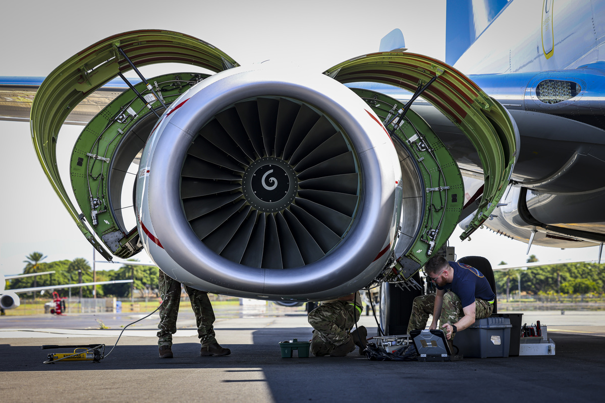Servicepeople working on the engine.