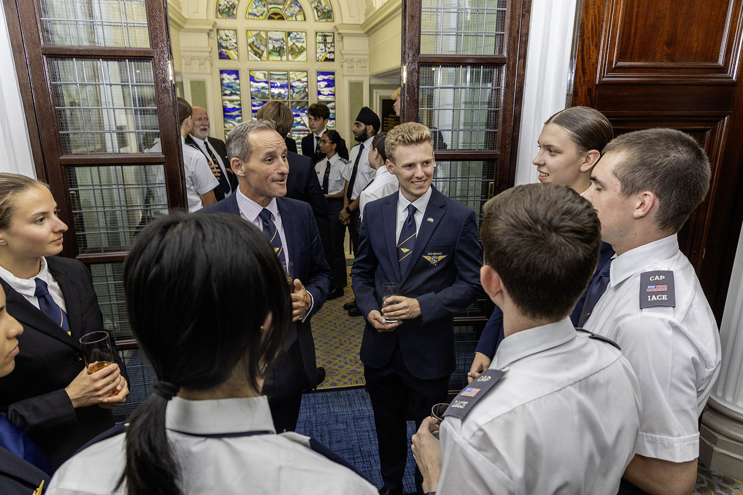 Commandant Air Cadets with cadets from Germany, USA and Sweden at The RAF Club dinner.