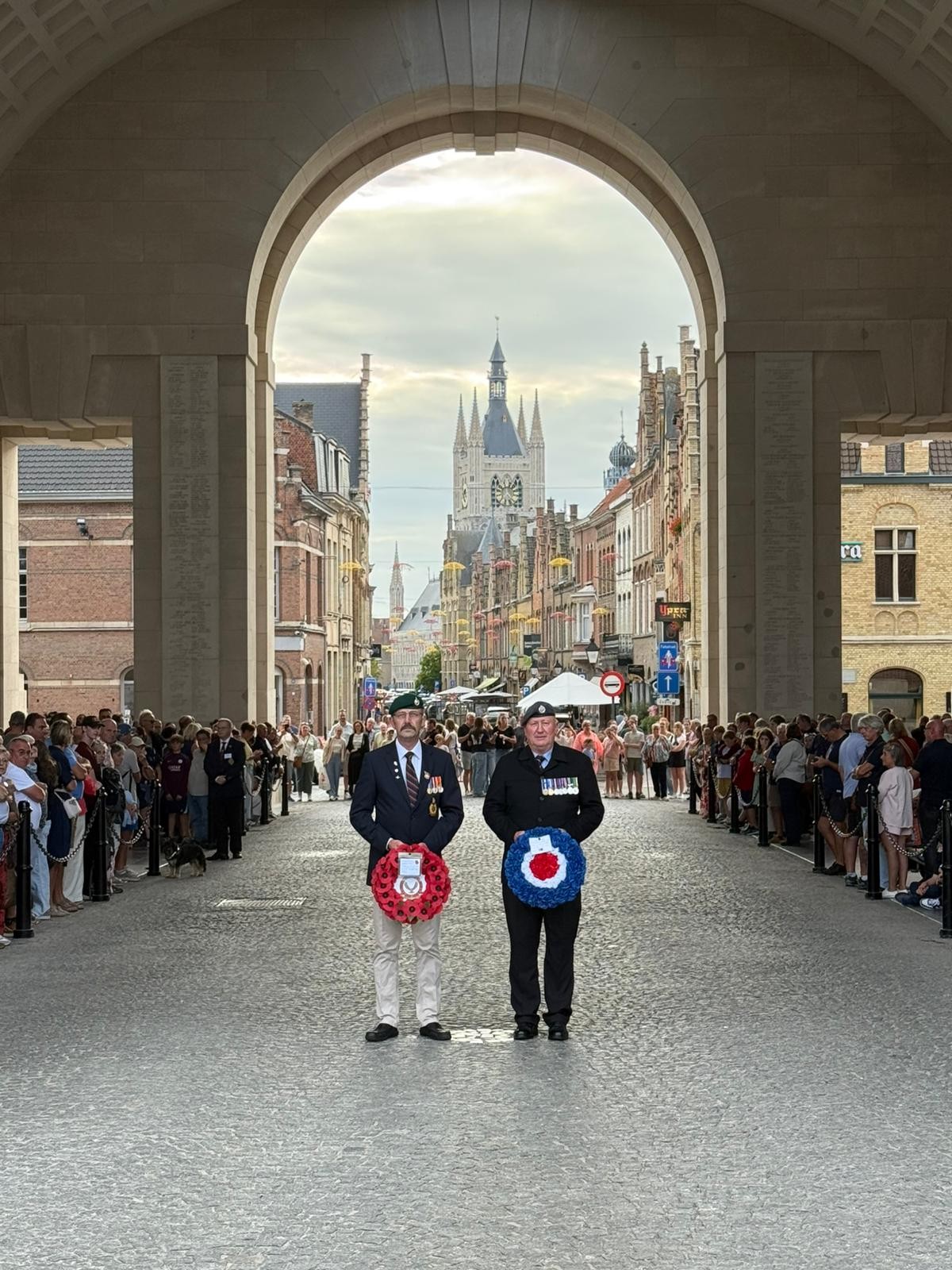 Staff stand with wreaths at the Menin Gate