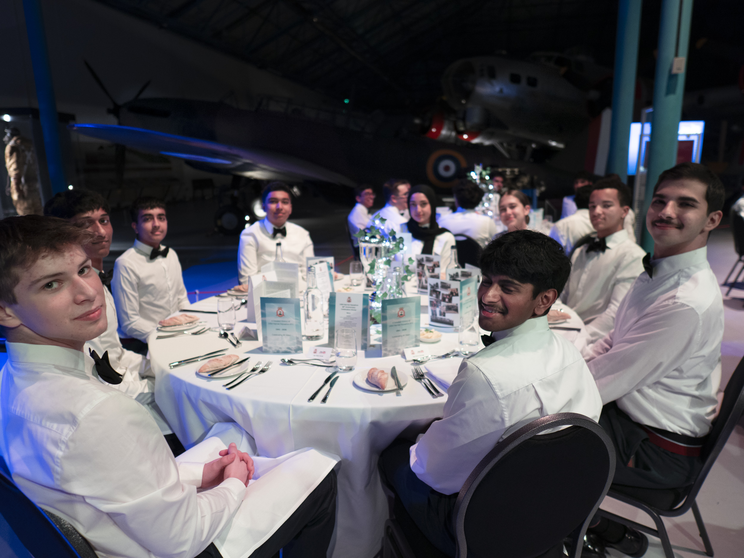 Cadets sat around a table waiting for the formal dinner
