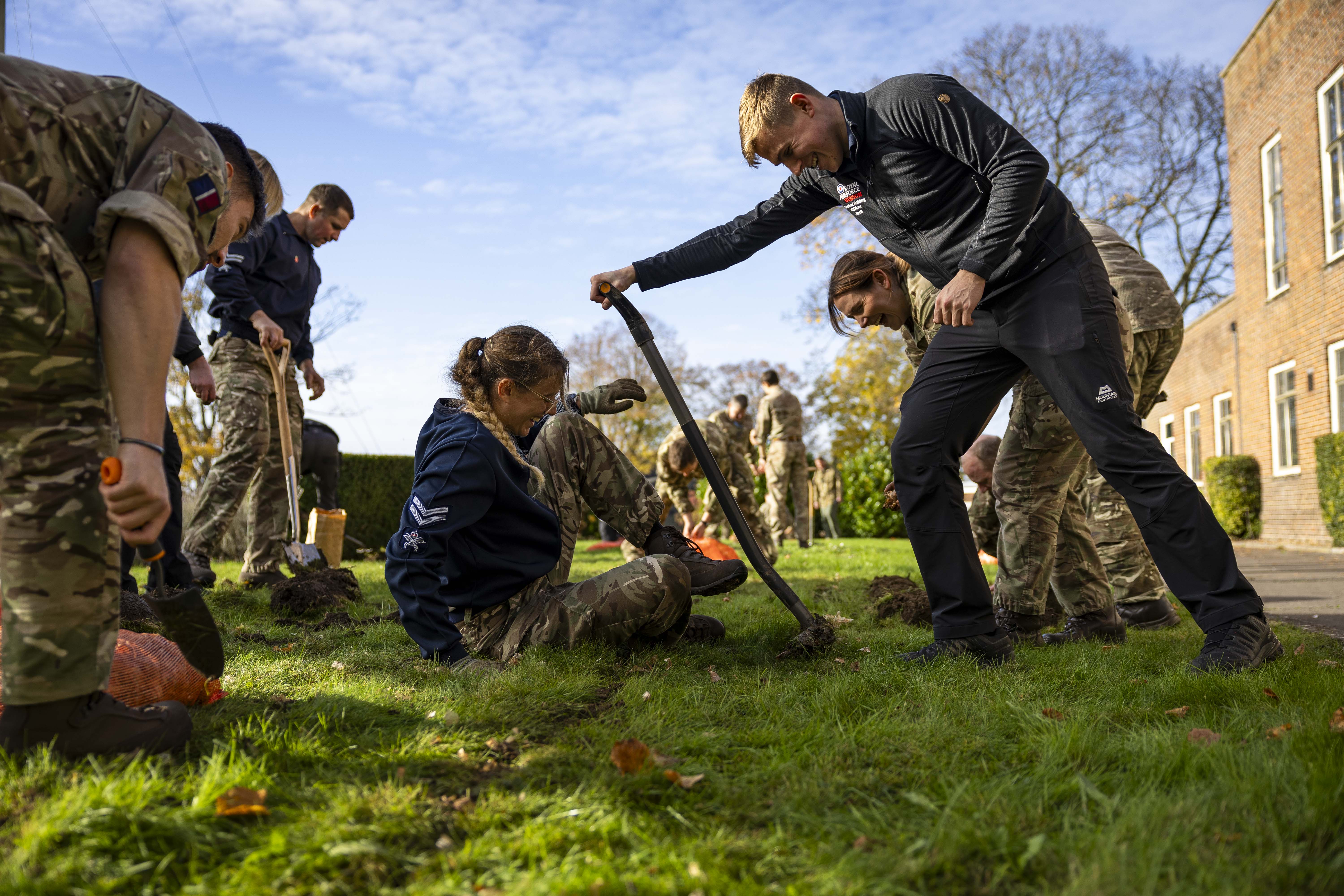 Personnel use shovels to dig the ground. 