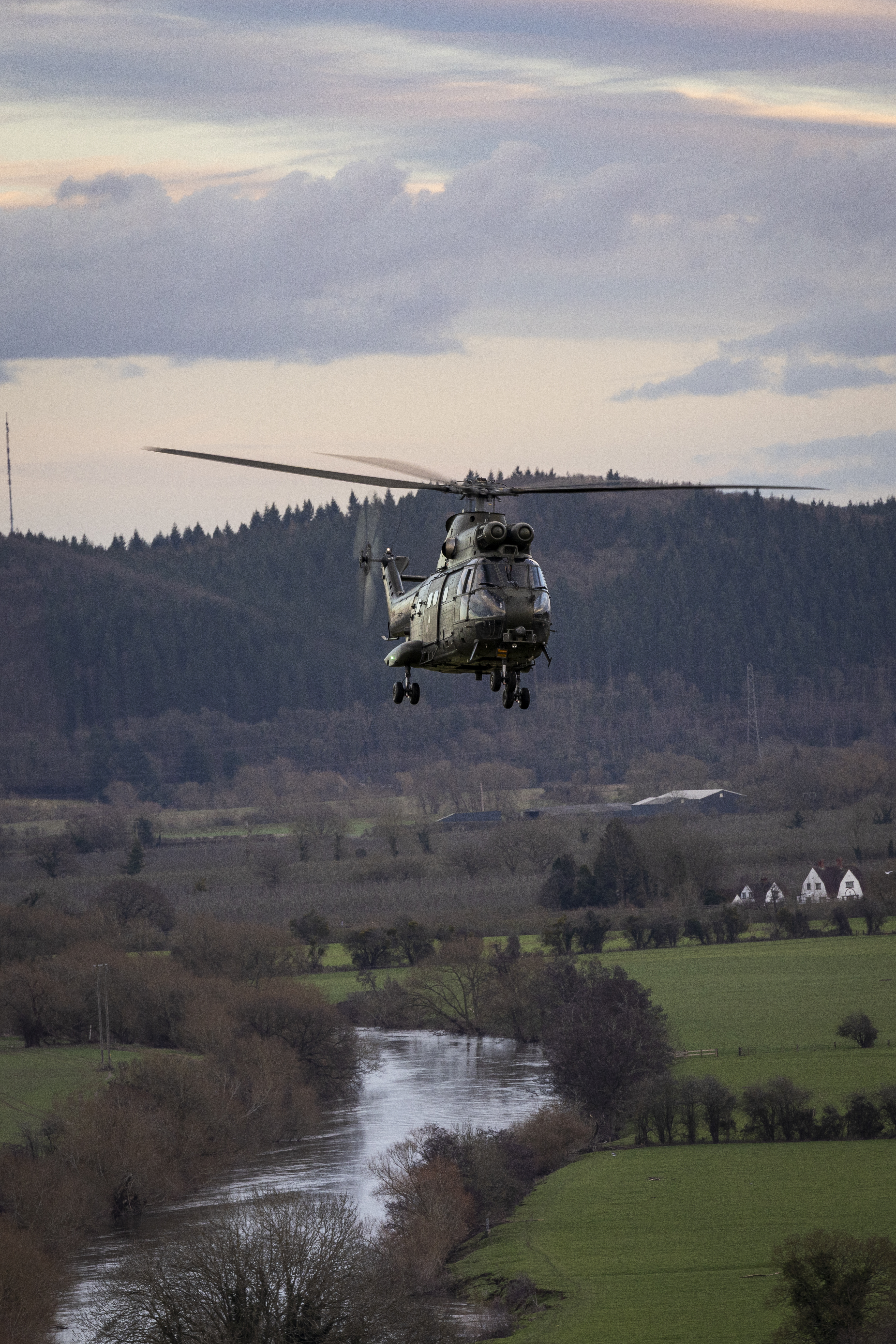 One RAF Puma flying alongside River Usk, Sennybridge, Wales.
