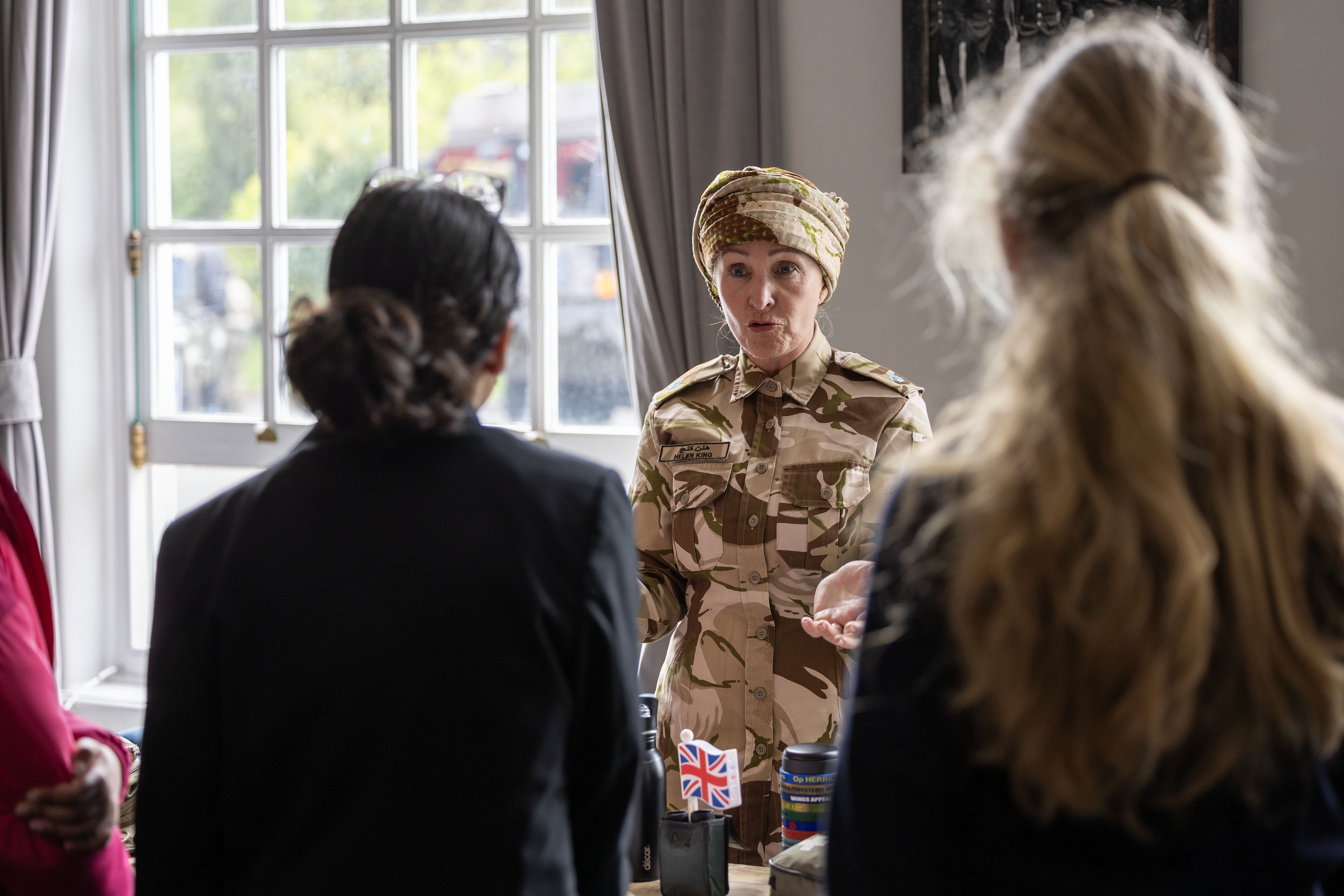 Sqn Ldr Grantham in Omani military uniform speaking to students from local school at RAF Benson.