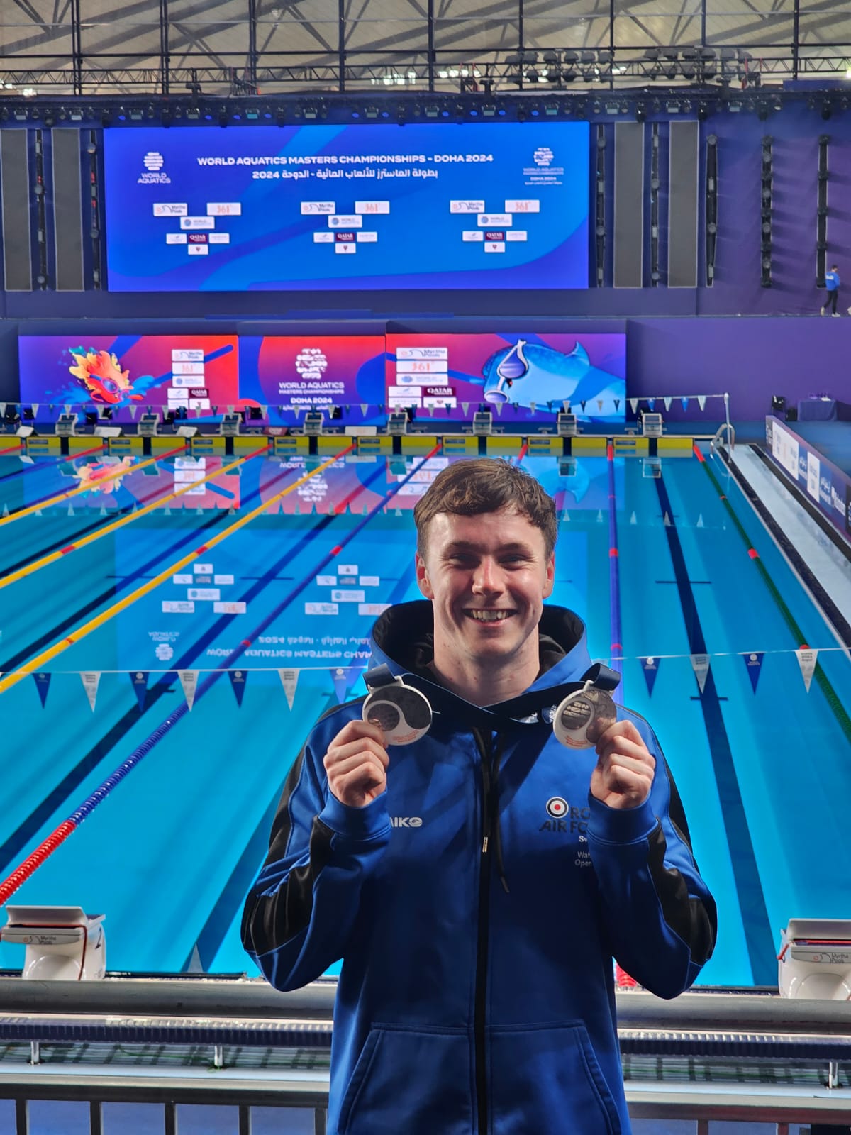 AS1 Holland with his medals poolside