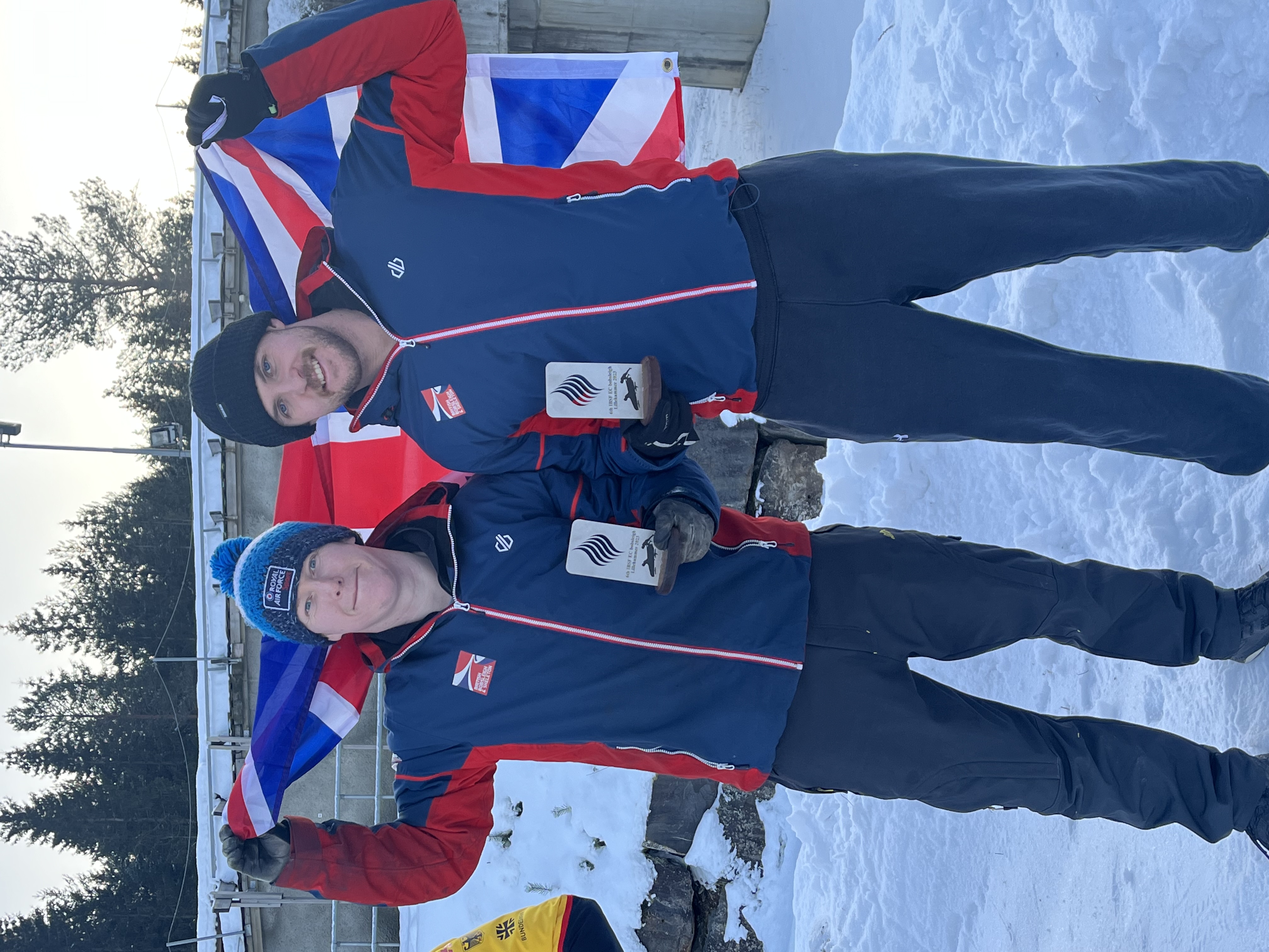 2-man bobsleigh team with Union Jack and trophies