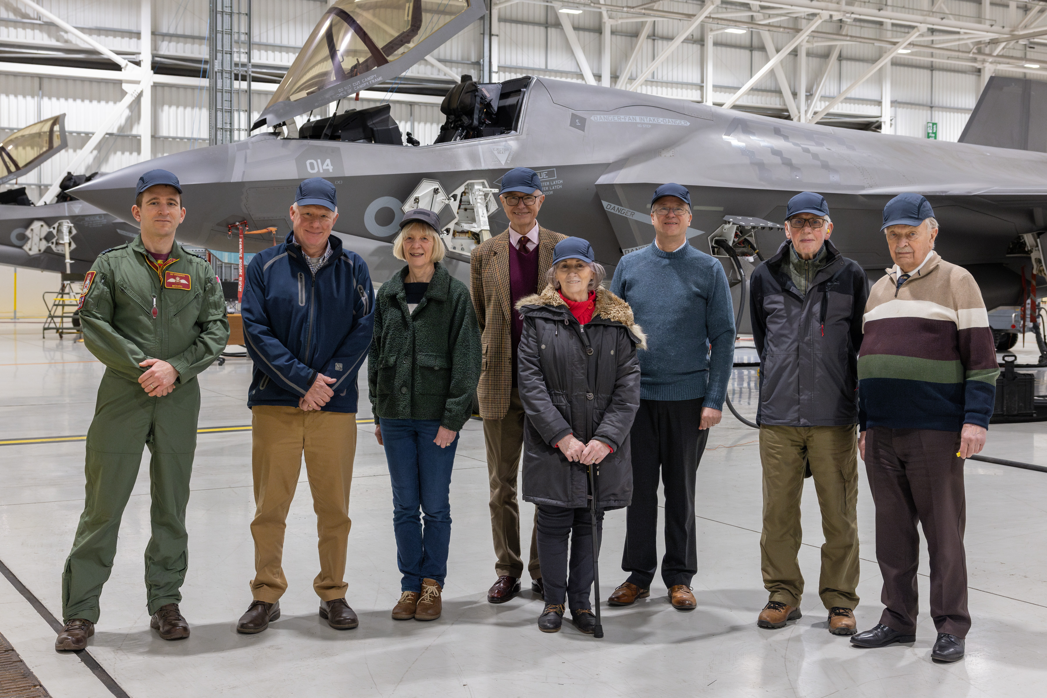 International Bomber Command Centre visitors posing for a photo in front of a F35B jet