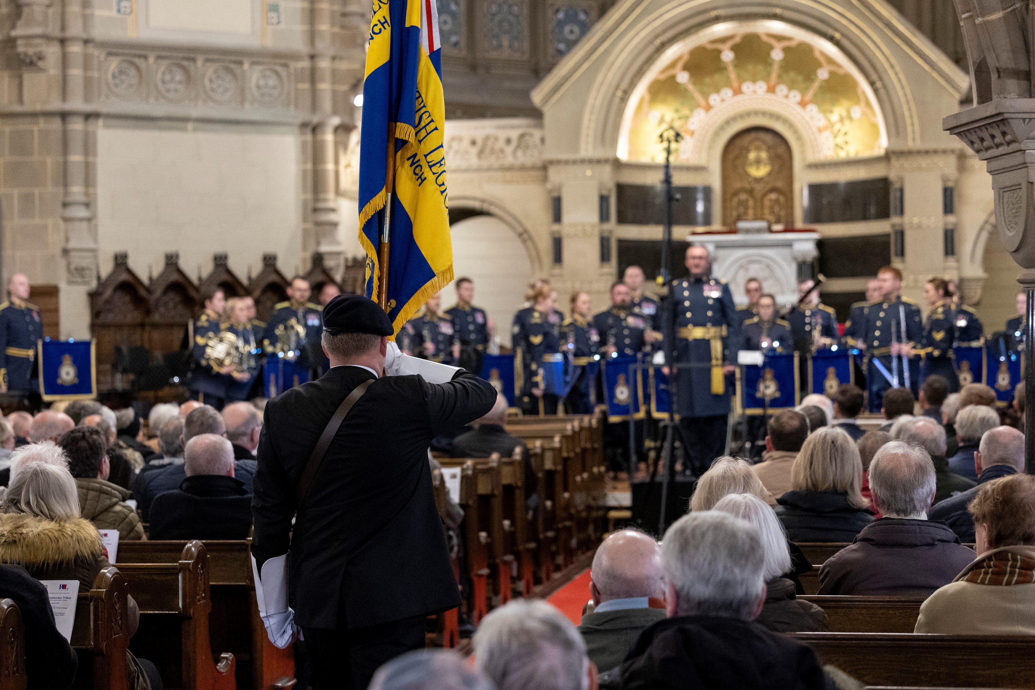 The Standard of the Rheindahlen Branch of the Royal British Legion was marched through the church at the beginning of the tribute.