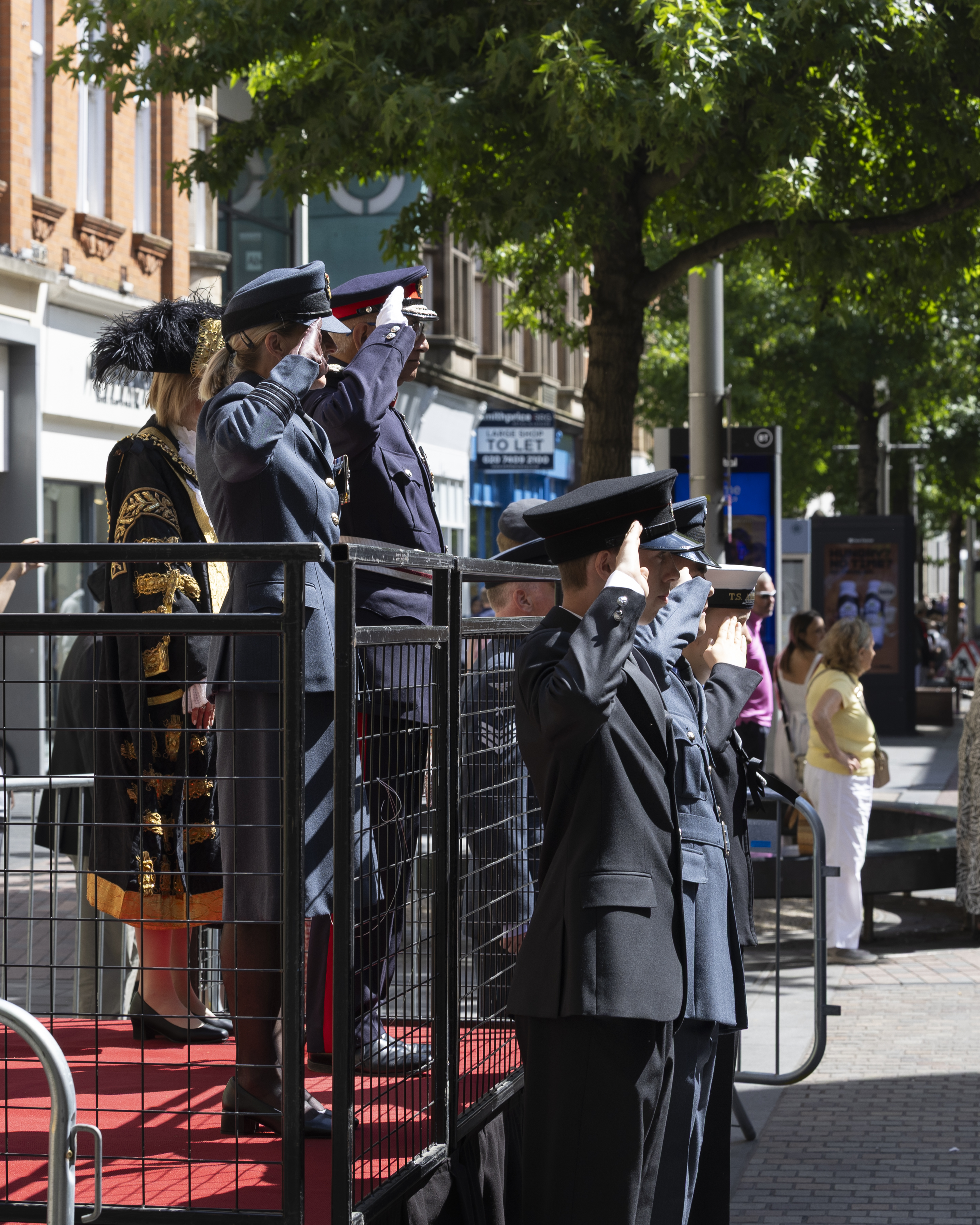 RAF Wittering Station Commander Wing Commander Nikki Duncan takes the salute alongside the Lord-Lieutenant of Leicestershire Mike Kapur OBE.