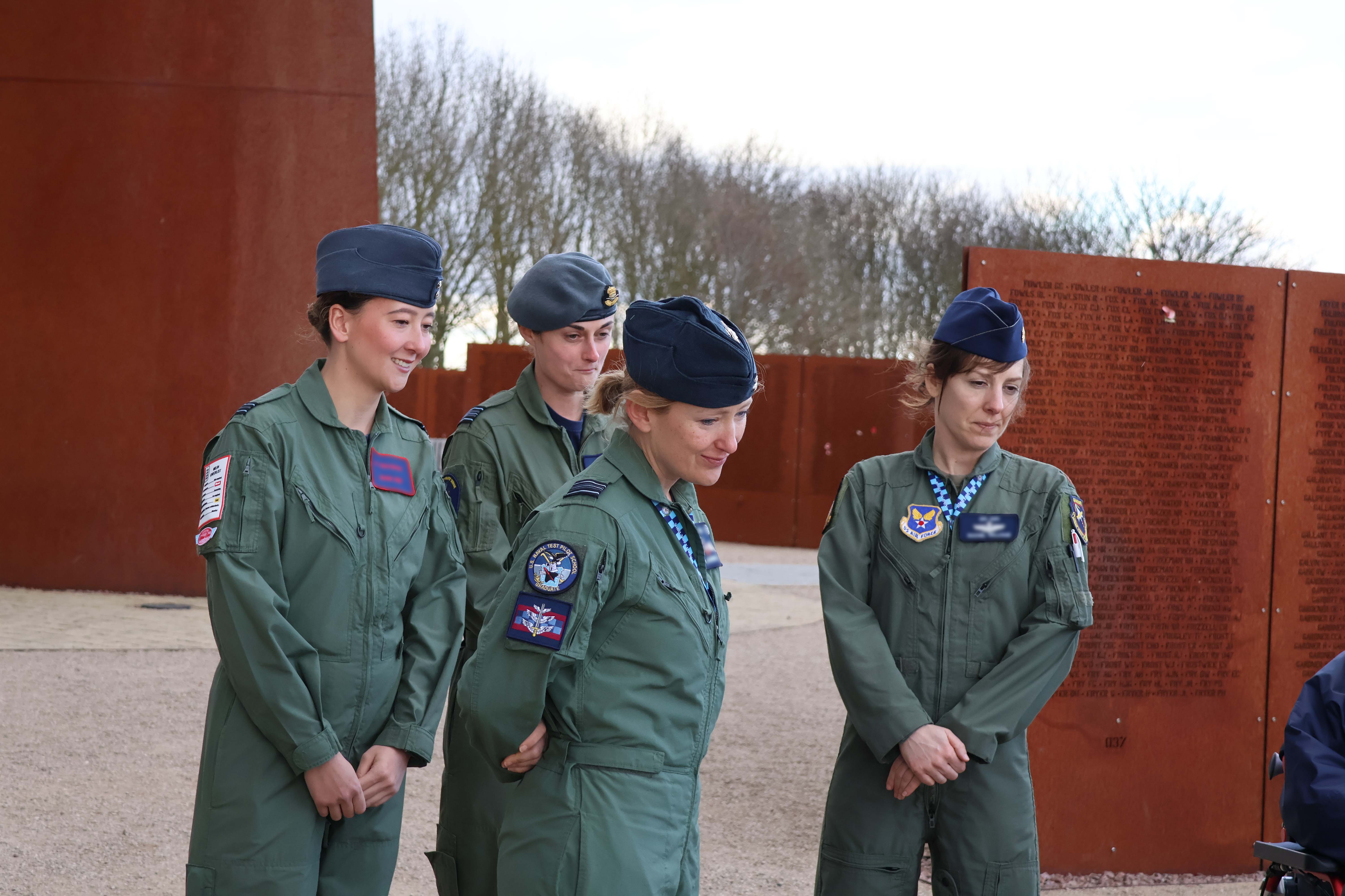 Four RAF personnel standing by the memorial.
