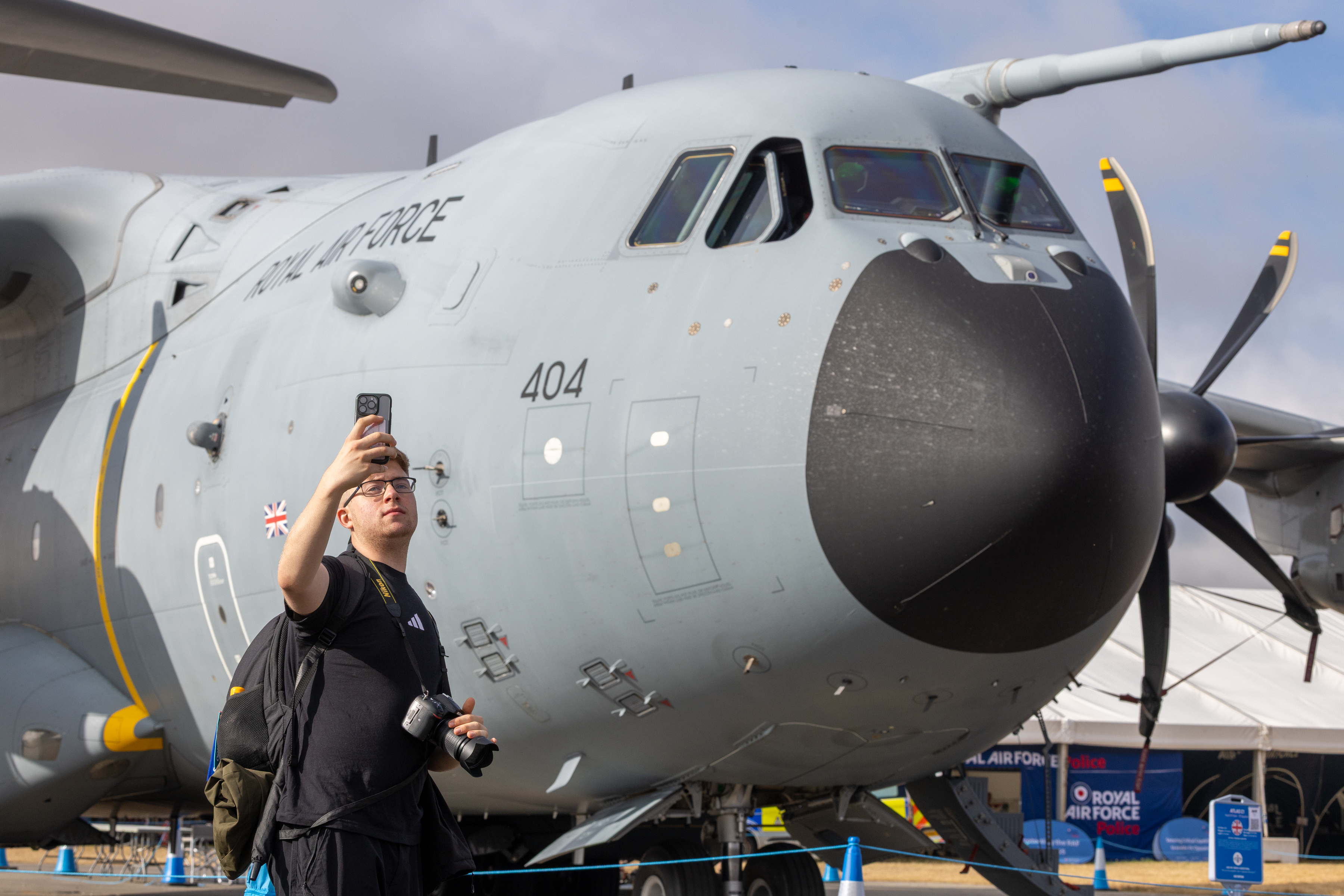 A spectator having a picture infront of the A400M at RIAT 2025.