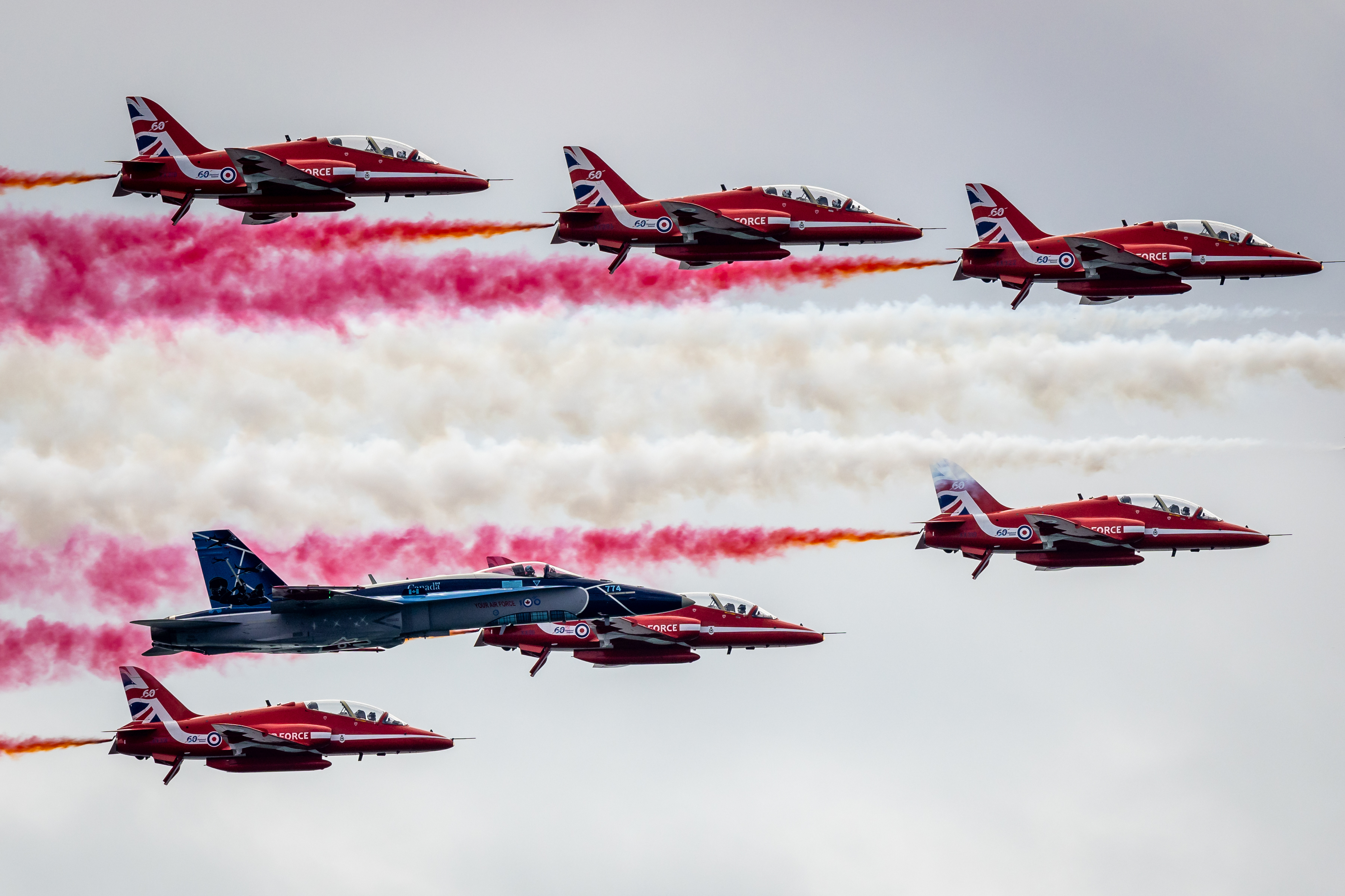 Partners: The Red Arrows and CF-18 perform the Commonwealth Pass.