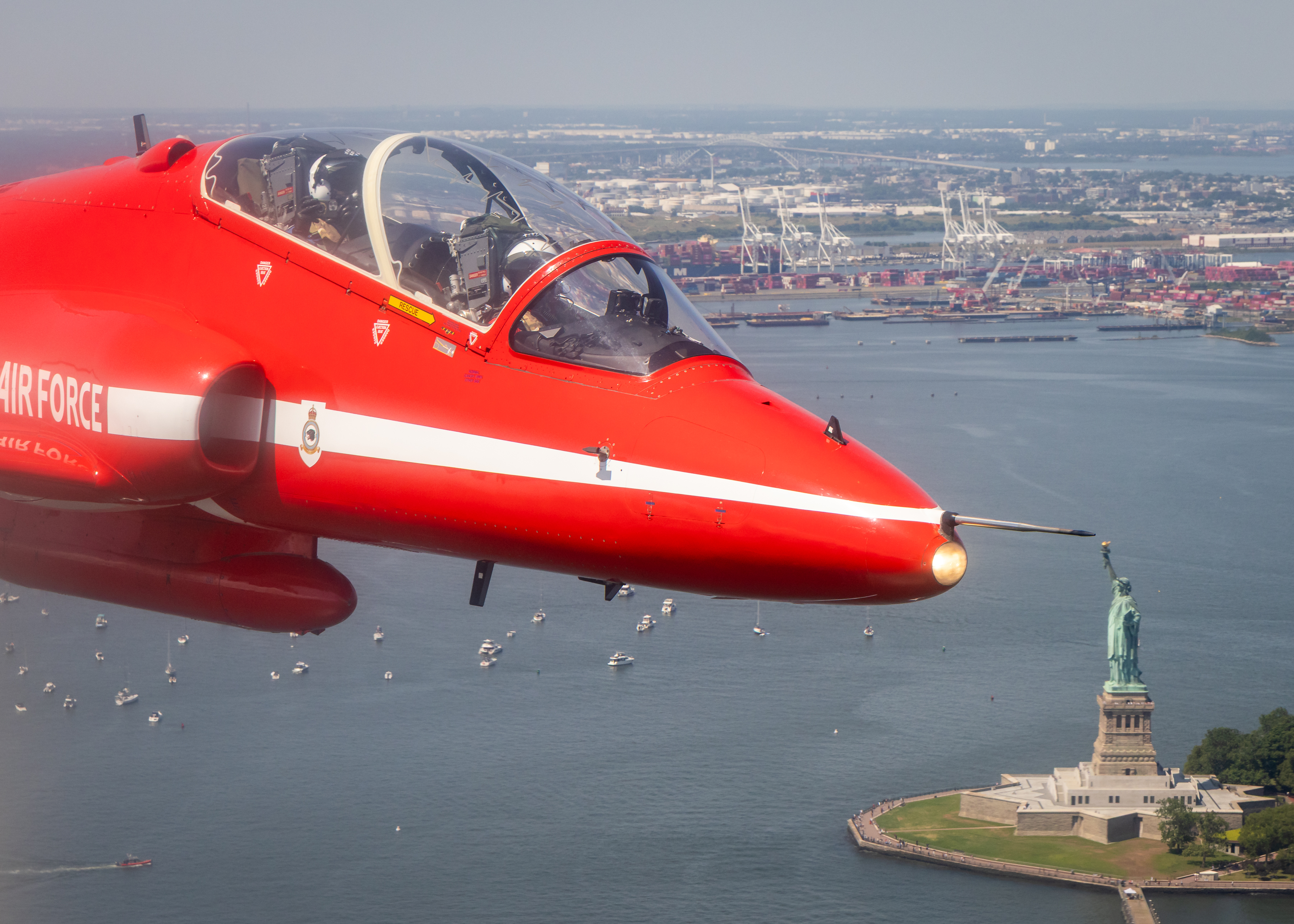 A Red Arrows jet is seen flying above the Statue of Liberty, New York.