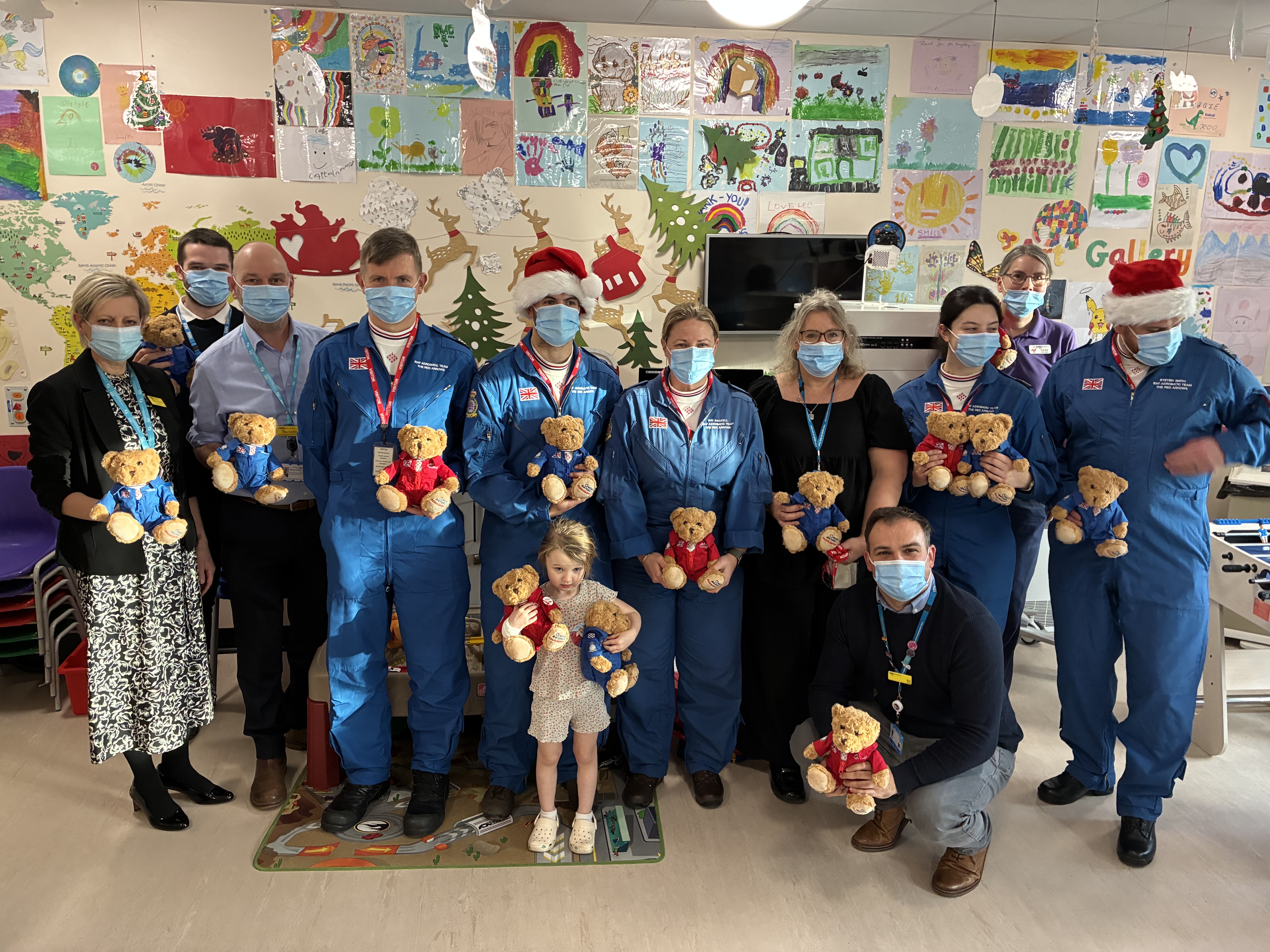 Red Arrows personnel stand next to children and staff at Lincoln County Hospital during a visit to hand out teddies following fundraising.