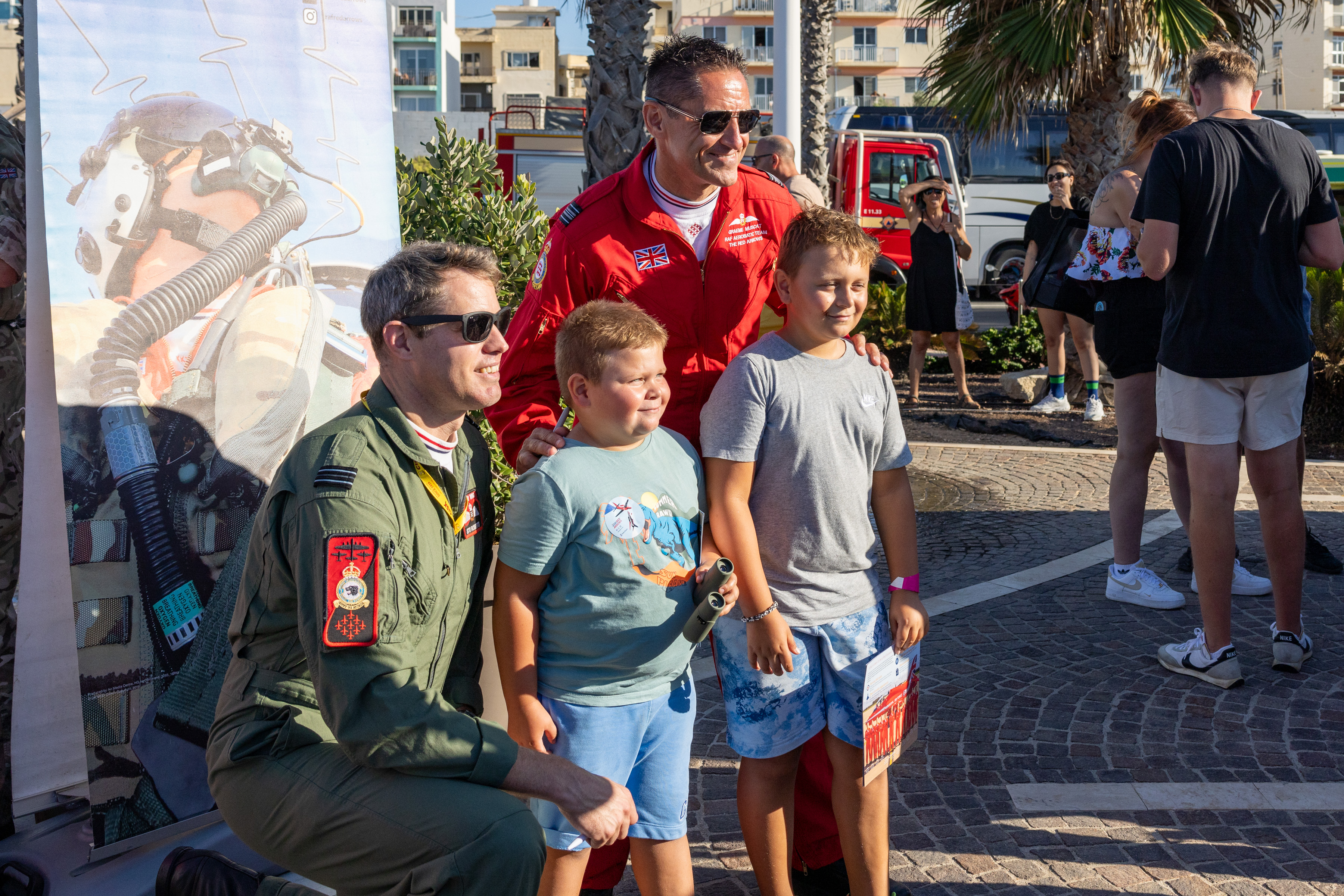 The new Red 10, Squadron Leader Stu Roberts, meets young airshow fans at an event alongside his predecessor in the role - Squadron Leader Graeme Muscat.
