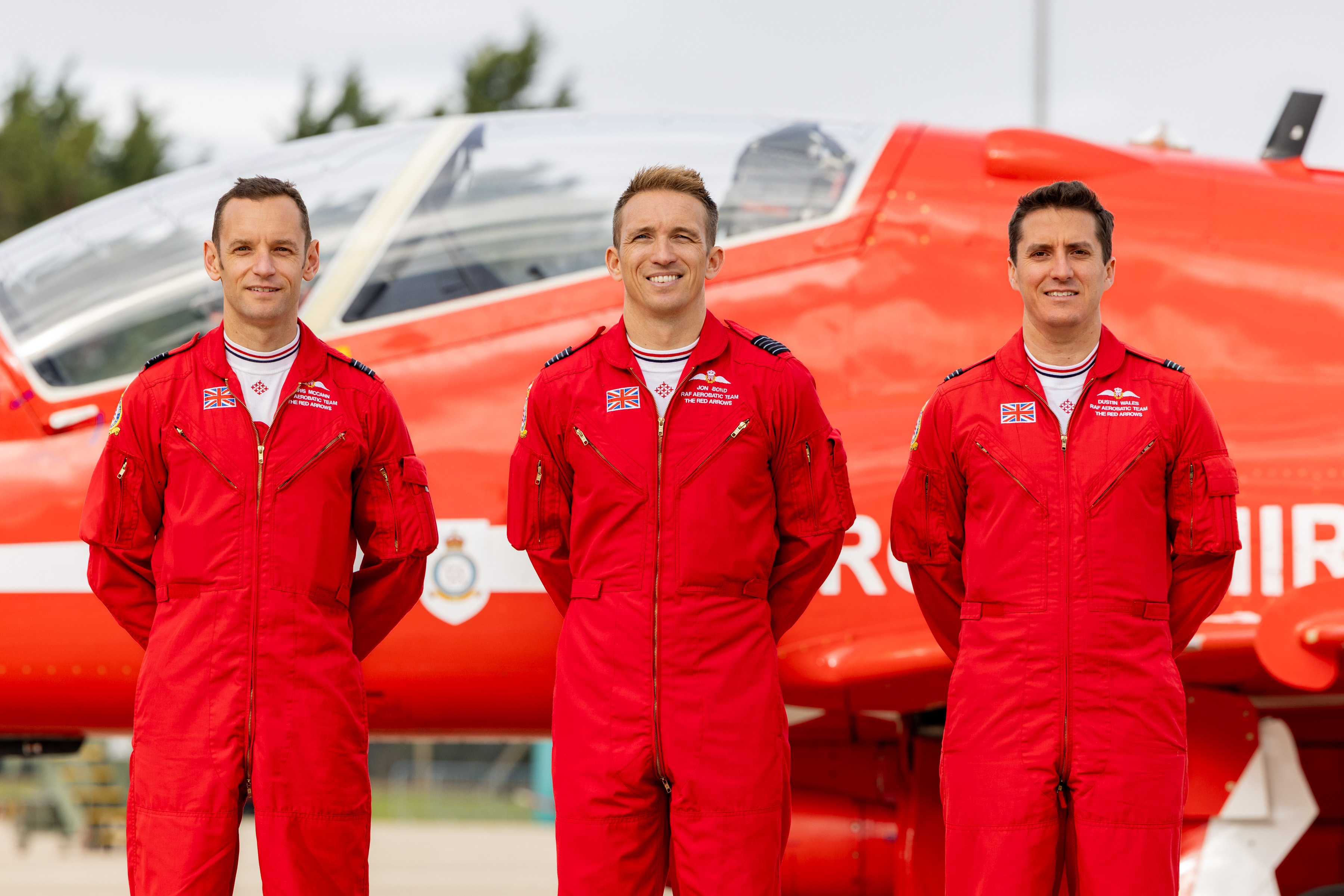 Standing in front of a Red Arrows jet - the three team pilots leaving after 2026 are (left-to-right in the picture): Squadron Leader Chris McCann, Wing Commander Jon Bond and Flight Lieutenant Dustin Wales.