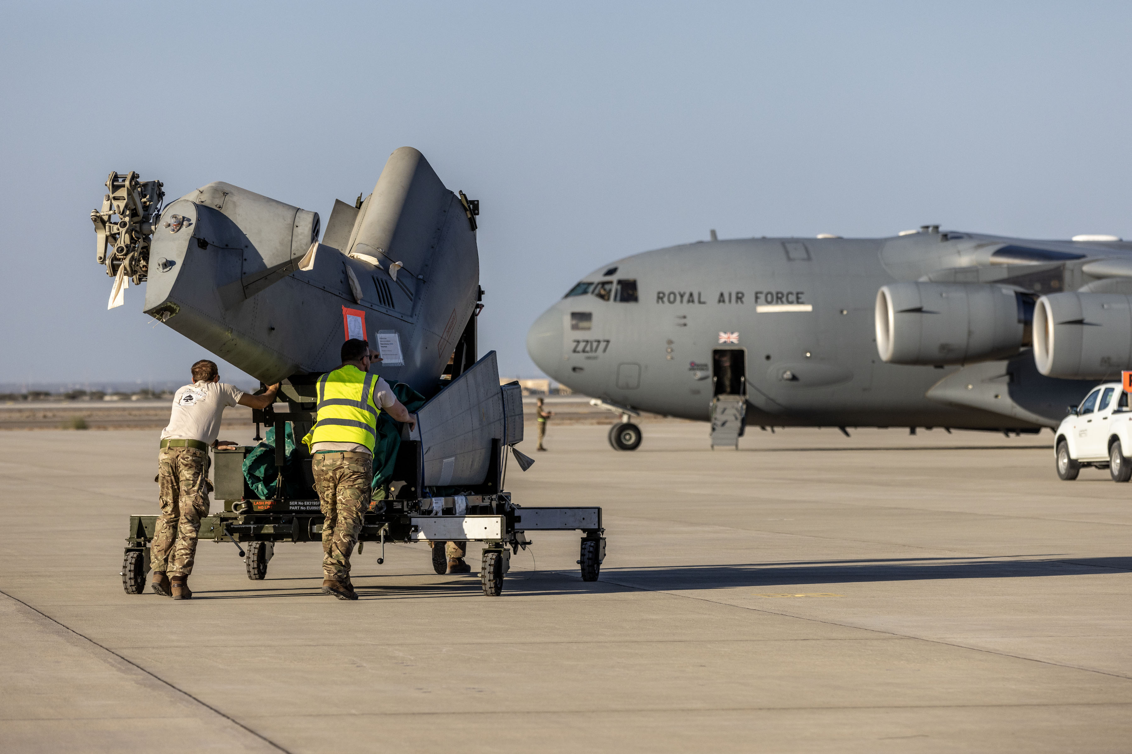 Merlin parts being taken on the runway to the C-17.