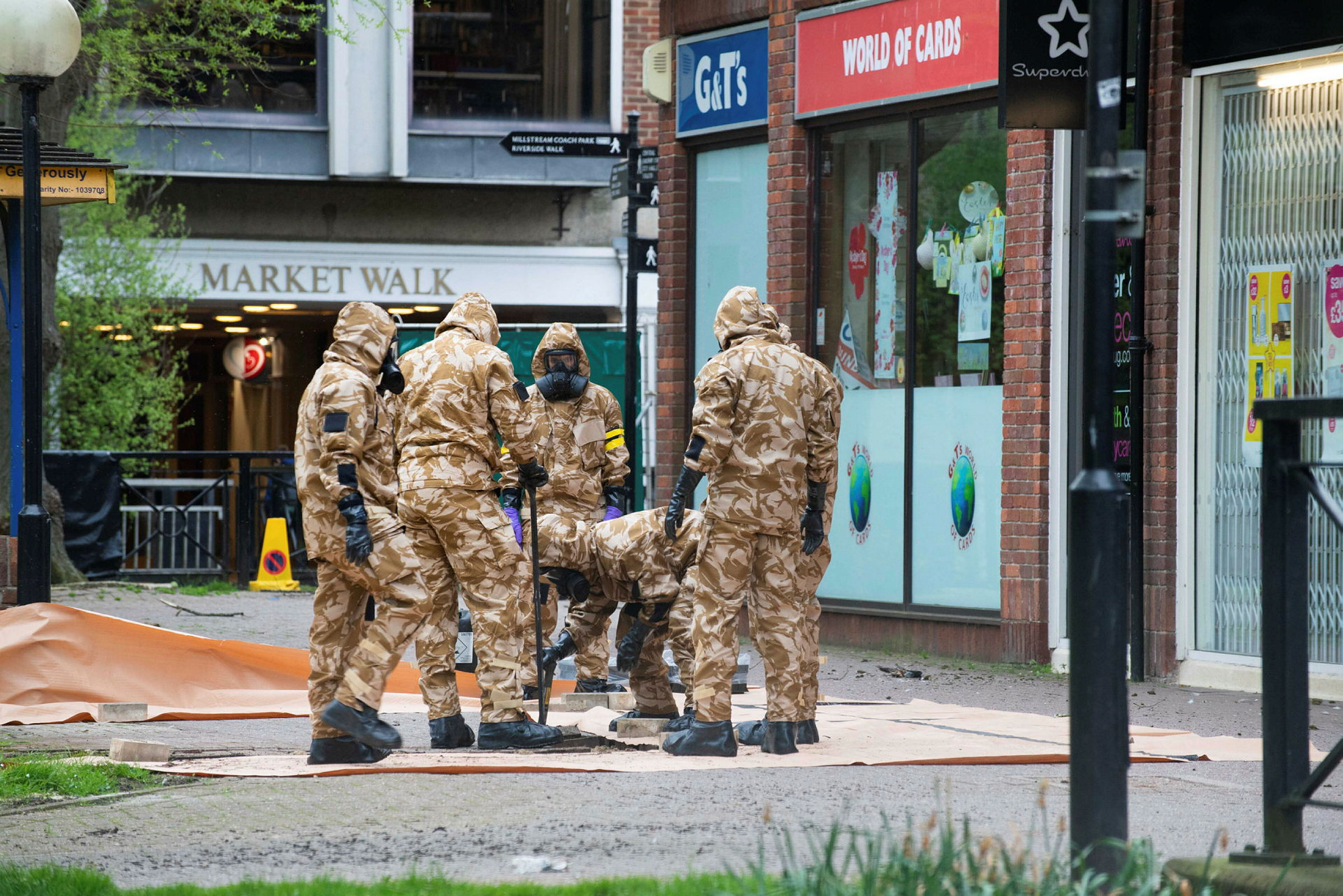 Personnel from the RAF Regiment undertaking decontamination measures in Salisbury city centre whilst wearing personal protective equipment.