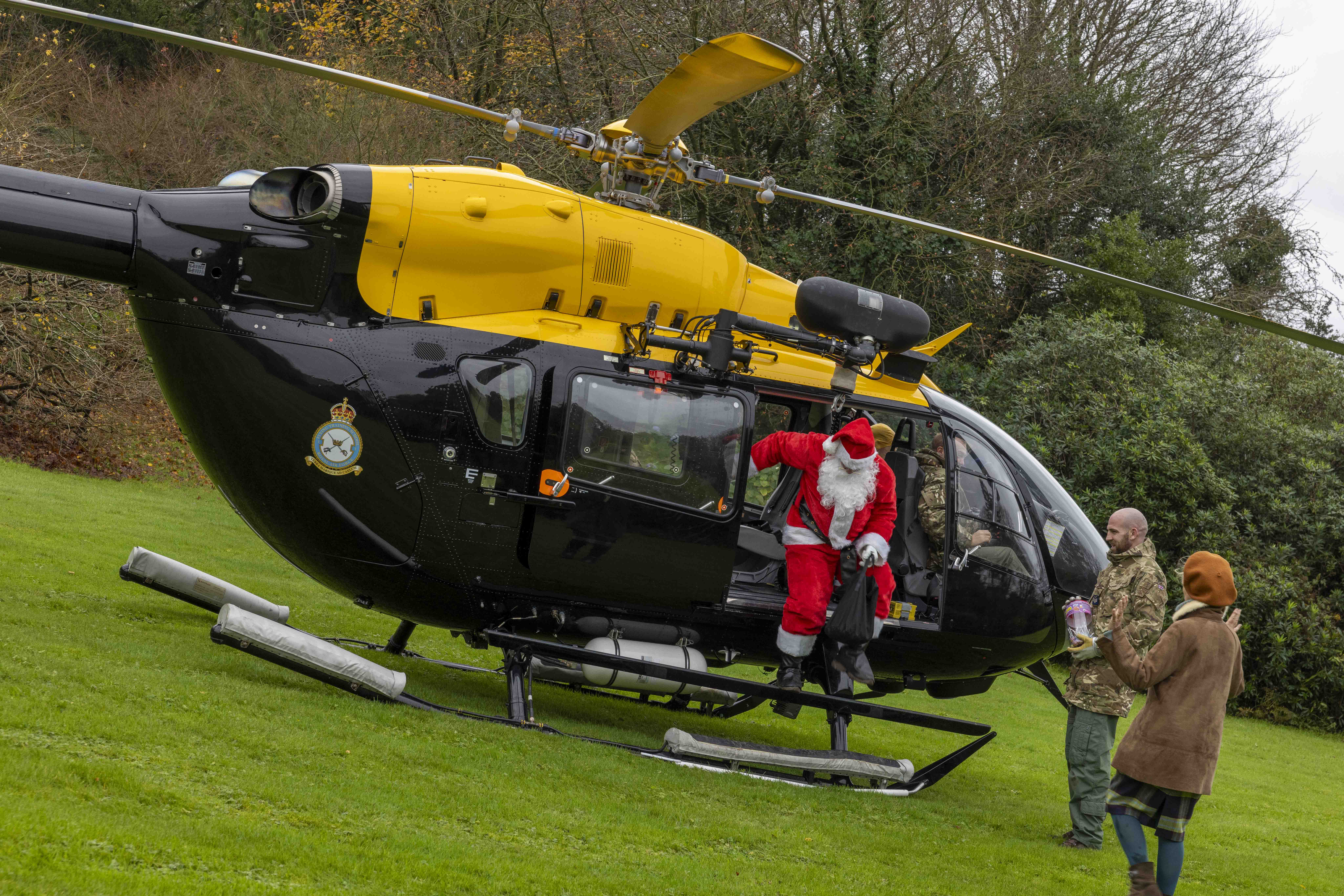 Santa climbs out of helicopter.