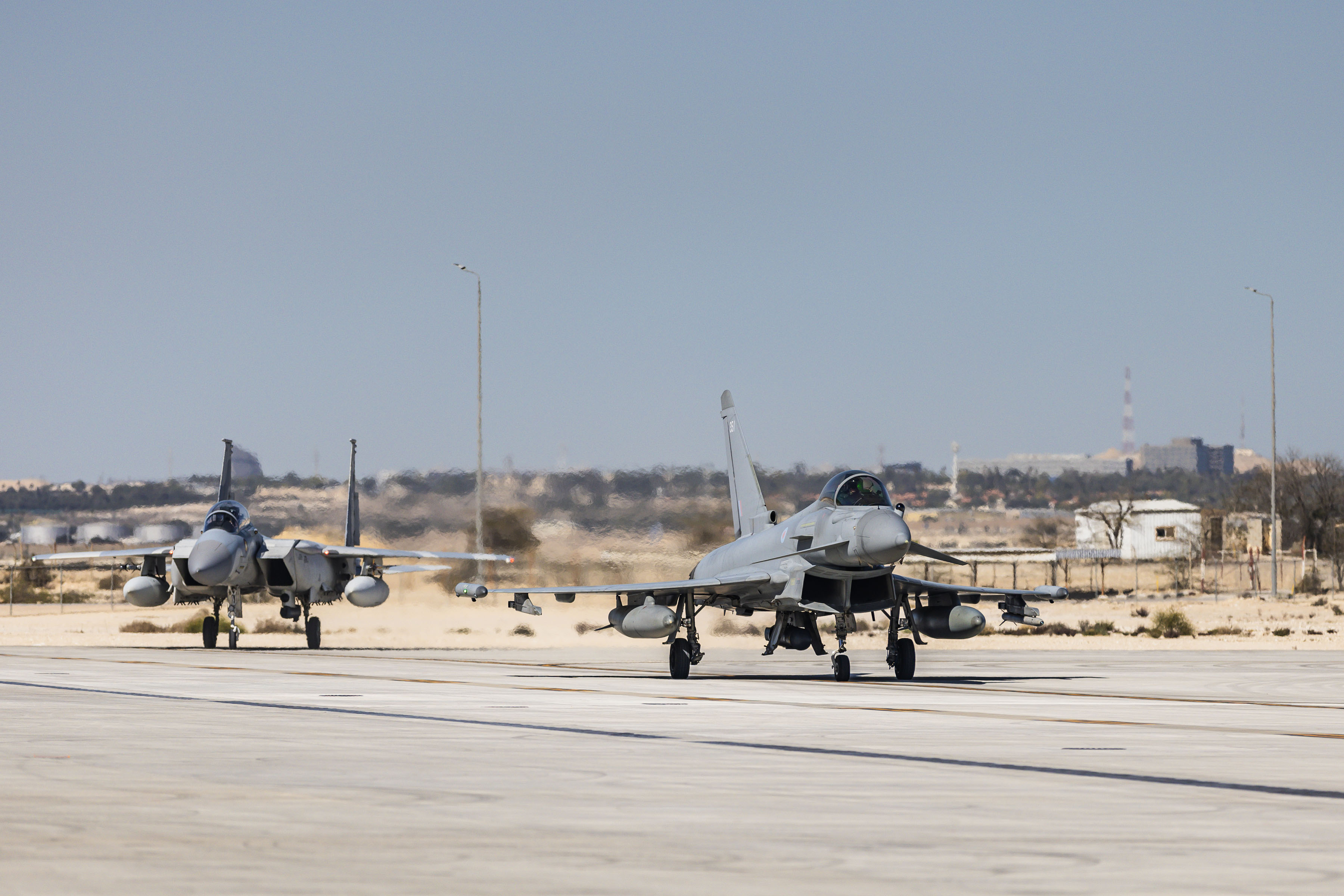 Typhoon on the runway with aircraft in the background