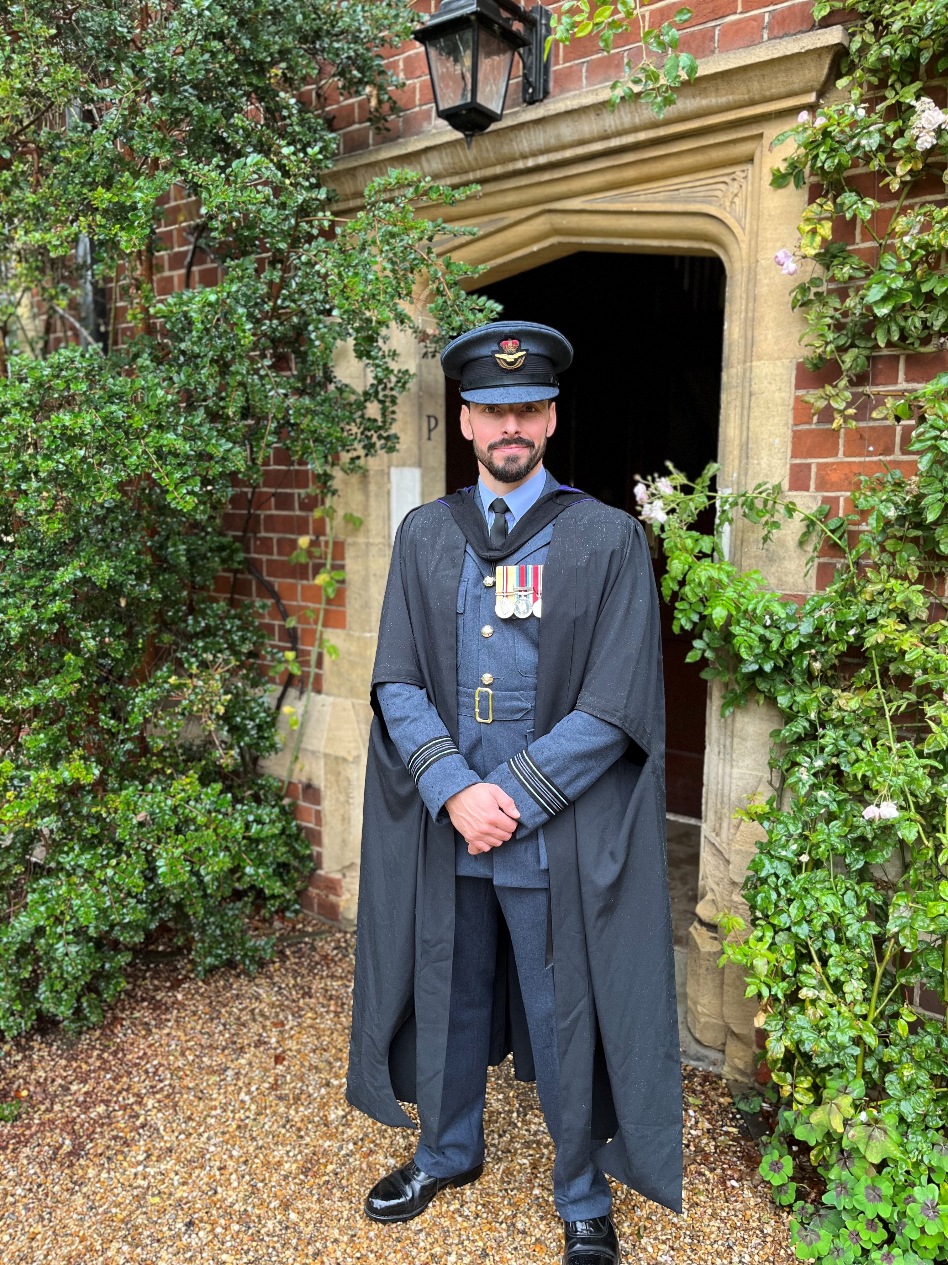 A photo of Squadron Leader Handley in graduation attire at Shrivenham.