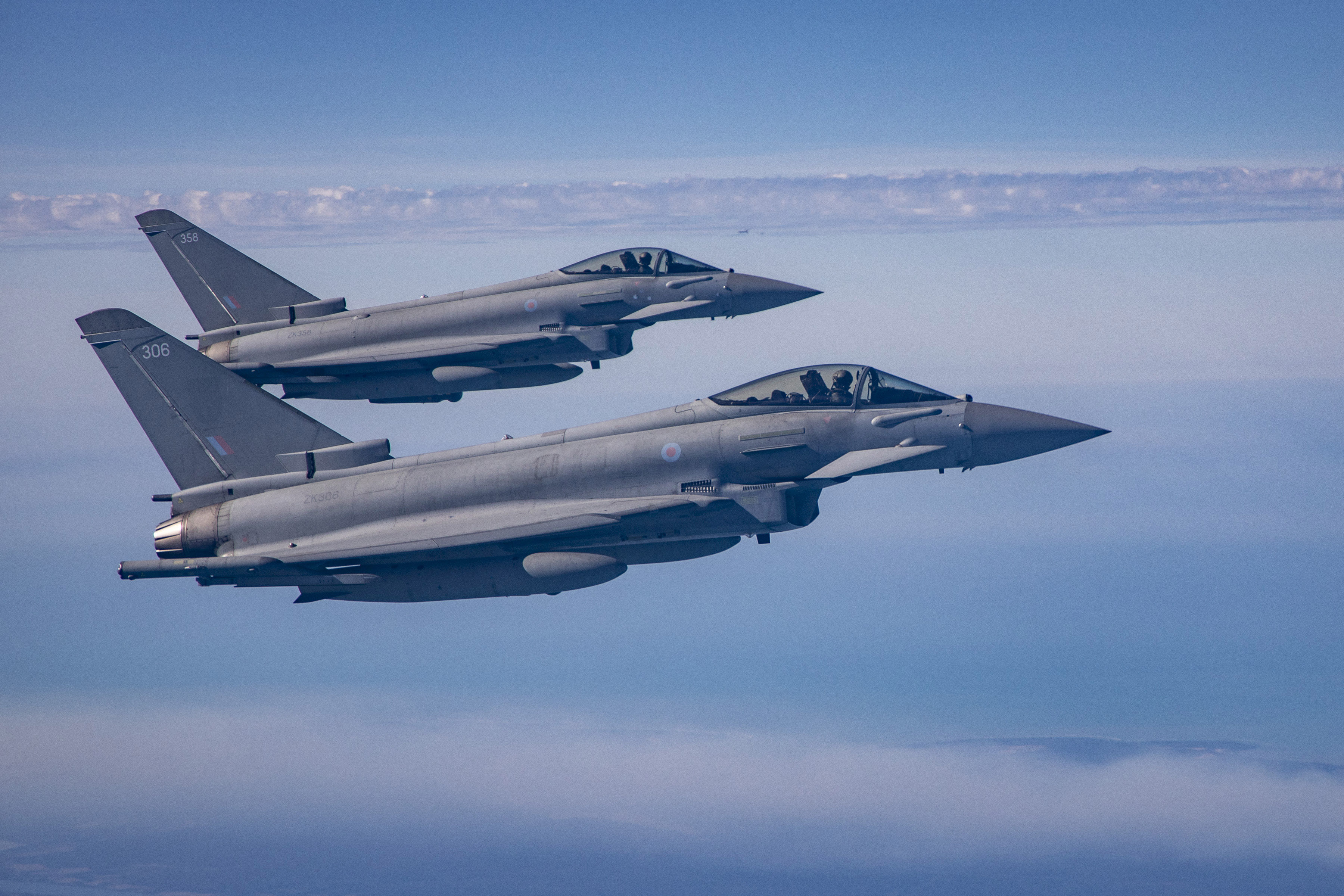 Two RAF Eurofighter Typhoons flying side-by-side against a blue sky.