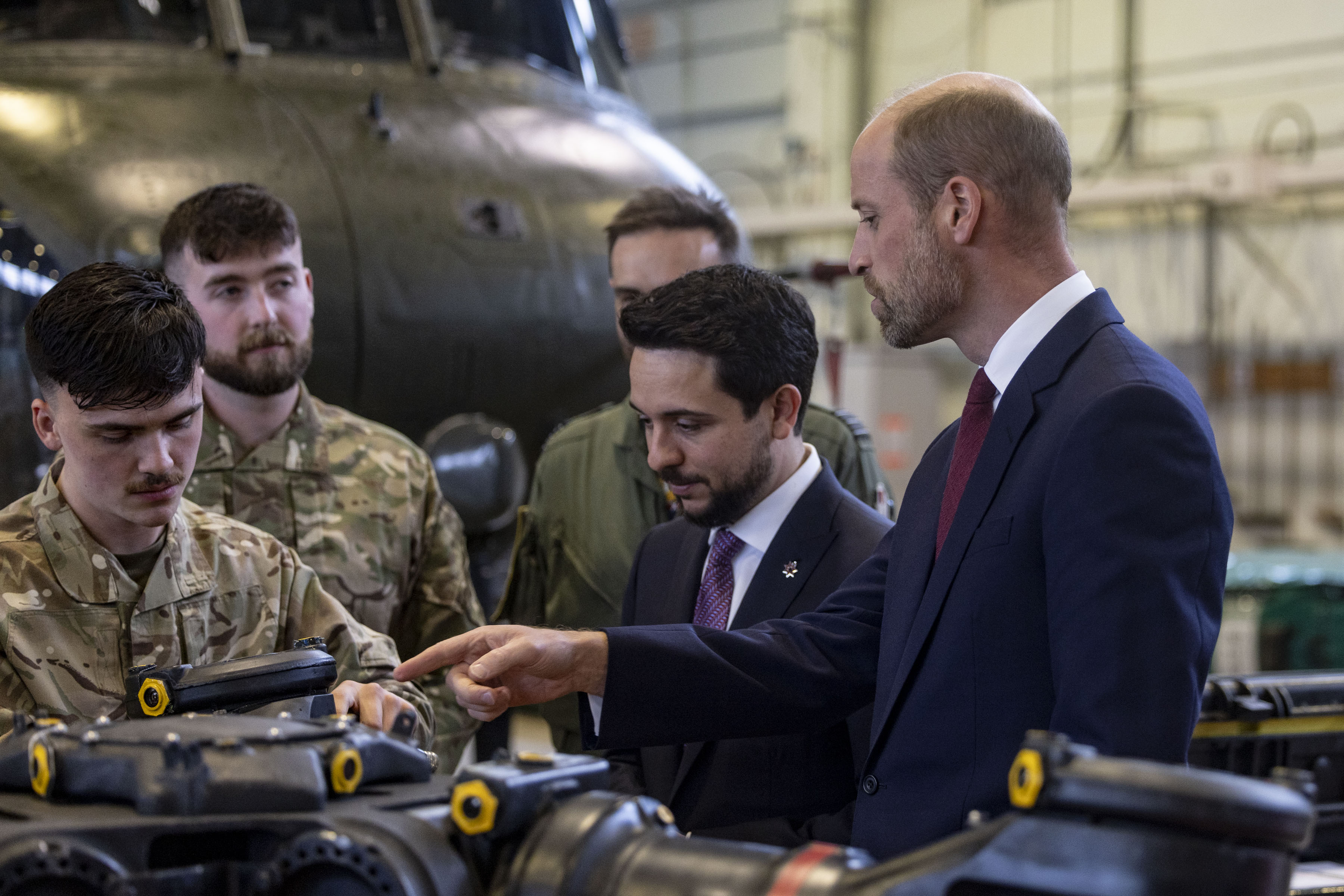 The Princes look a a rotor head surrounded by several Technicians.